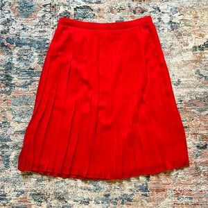Red pleated midi skirt